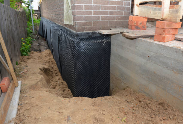 Happy homeowners after waterproofing job in Quincy